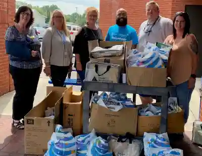 Image of members of AT&T and Junior Achievement with first day of school supply bags